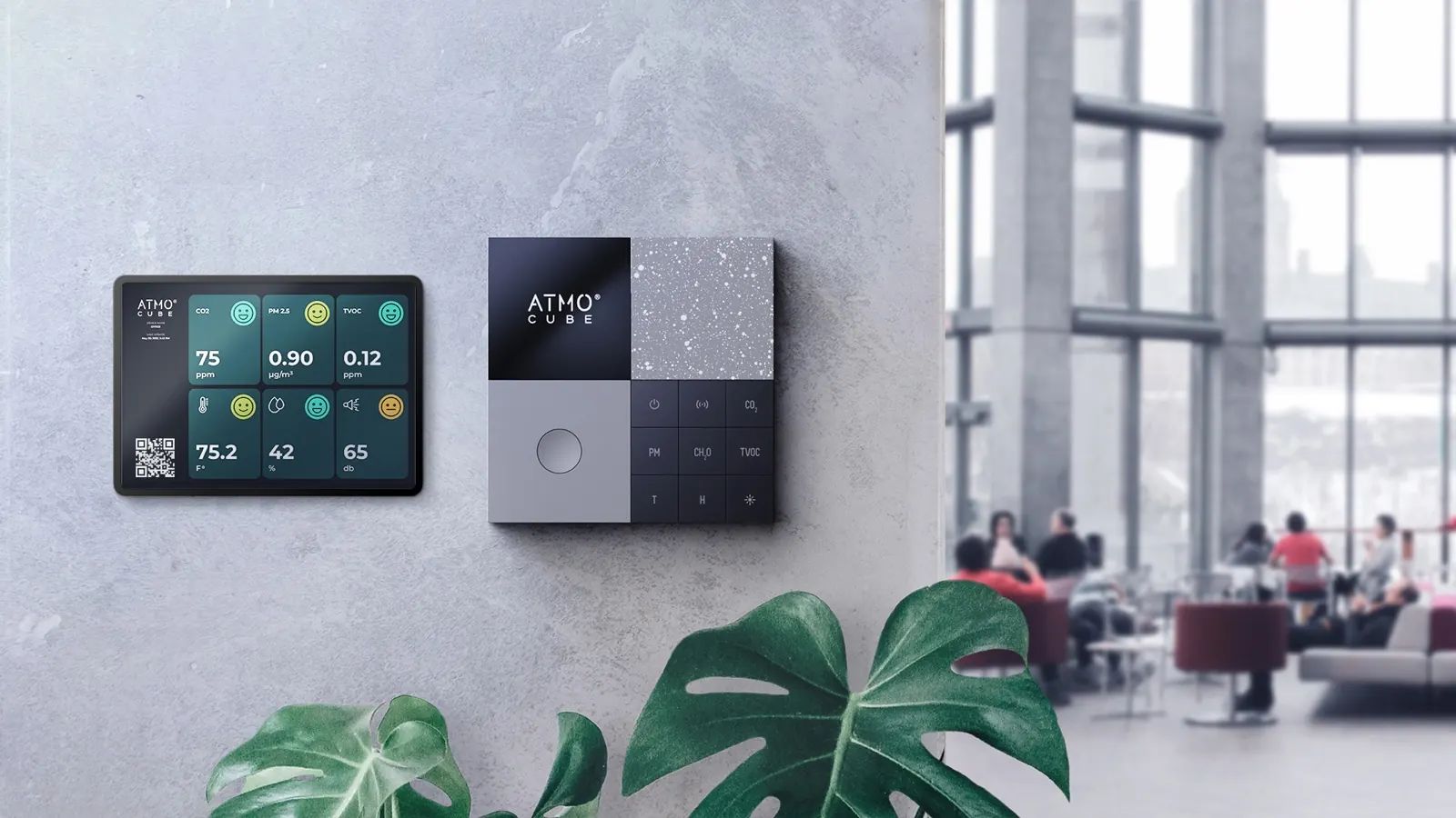 An air quality monitor and its readings on an office wall